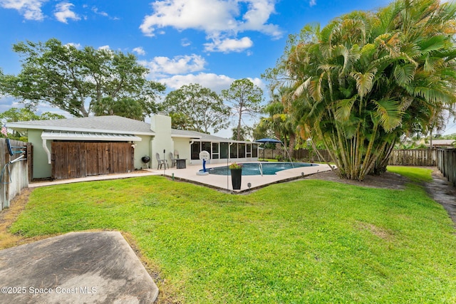 416 Catalina Ave NW, Palm Bay, FL 32907 - back of house with a fenced backyard, a sunroom, a chimney, a patio area, and stucco siding