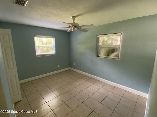 208 Johnson Ave, Cape Canaveral, FL 32920 - tiled spare room with a ceiling fan and baseboards
