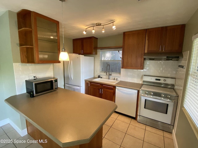 208 Johnson Ave, Cape Canaveral, FL 32920 - kitchen featuring appliances with stainless steel finishes, under cabinet range hood, tasteful backsplash, open shelves, and light tile patterned flooring
