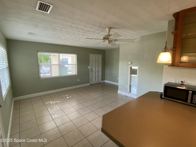 208 Johnson Ave, Cape Canaveral, FL 32920 - unfurnished living room with light tile patterned floors and ceiling fan