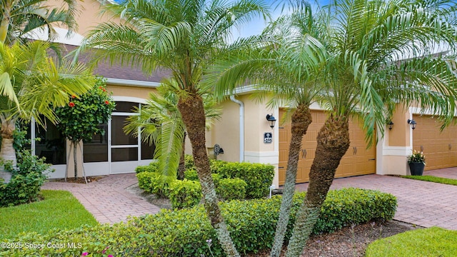 5727 Tamarac Dr, Melbourne, FL 32940 - community sign with decorative driveway and an attached garage