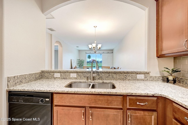 5727 Tamarac Dr, Melbourne, FL 32940 - kitchen with black dishwasher, light stone countertops, a chandelier, brown cabinetry, and arched walkways