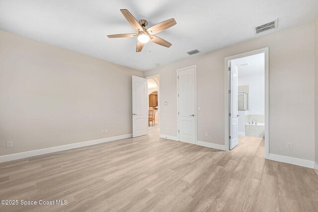5727 Tamarac Dr, Melbourne, FL 32940 - unfurnished bedroom with light wood-type flooring and ensuite bath