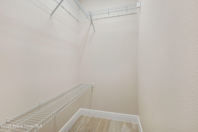 5727 Tamarac Dr, Melbourne, FL 32940 - walk in closet featuring wood finished floors
