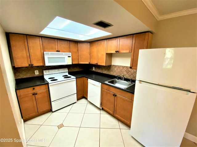 261 Cape Shores Cir Unit 18I, Cape Canaveral, FL 32920 - kitchen featuring white appliances, ornamental molding, dark countertops, decorative backsplash, and brown cabinetry
