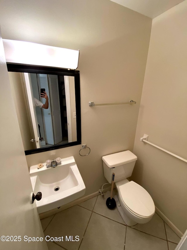 261 Cape Shores Cir Unit 18I, Cape Canaveral, FL 32920 - bathroom featuring a sink and tile patterned flooring
