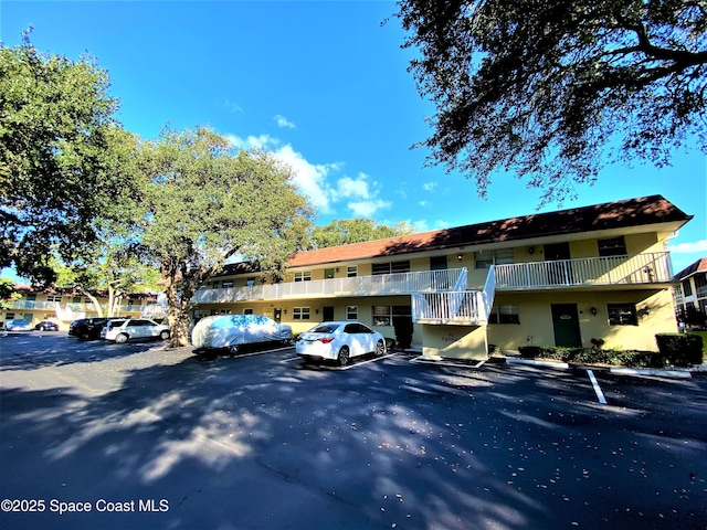 261 Cape Shores Cir Unit 18I, Cape Canaveral, FL 32920 - view of building exterior featuring uncovered parking