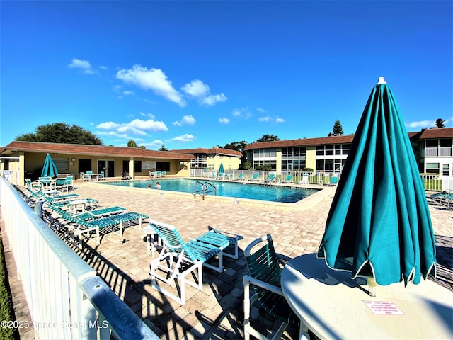 261 Cape Shores Cir Unit 18I, Cape Canaveral, FL 32920 - community pool featuring a patio area