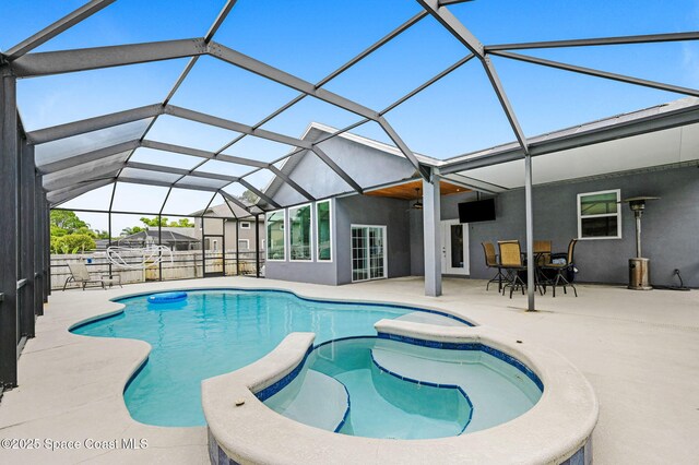 1067 Red Bud Cir, Rockledge, FL 32955 - view of swimming pool featuring a patio, glass enclosure, and a pool with connected hot tub