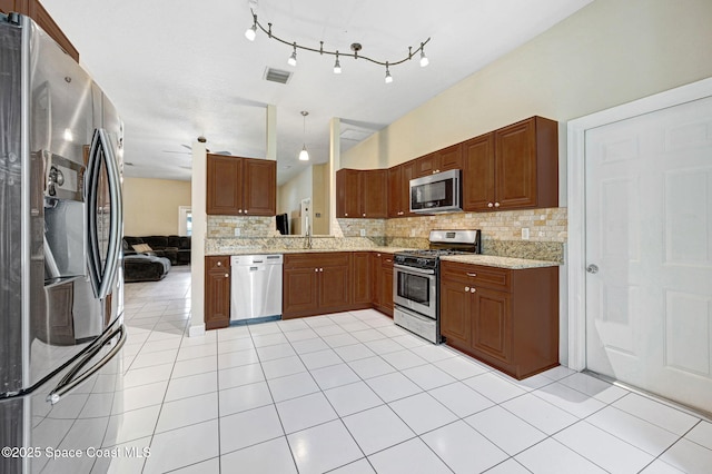 1067 Red Bud Cir, Rockledge, FL 32955 - kitchen featuring stainless steel appliances, decorative backsplash, and light tile patterned floors