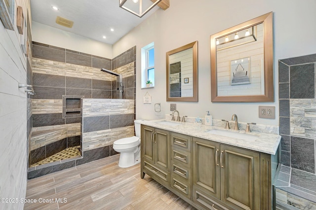 1067 Red Bud Cir, Rockledge, FL 32955 - bathroom featuring walk in shower, double vanity, wood finished floors, and recessed lighting