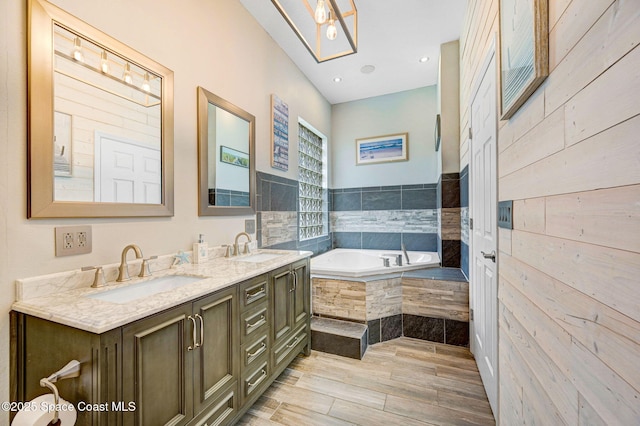 1067 Red Bud Cir, Rockledge, FL 32955 - bathroom featuring a bath, double vanity, and wood finished floors