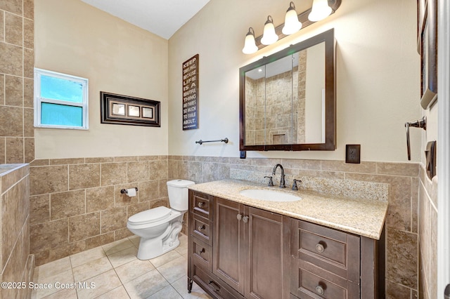 1067 Red Bud Cir, Rockledge, FL 32955 - full bathroom featuring tile walls, vanity, tile patterned flooring, and a wainscoted wall