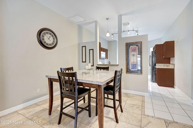 1067 Red Bud Cir, Rockledge, FL 32955 - dining space with light tile patterned flooring and rail lighting