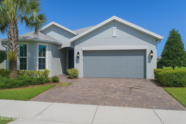 10035 SW Captiva Dr, Port St Lucie, FL 34987 - single story home featuring stucco siding, decorative driveway, and a garage