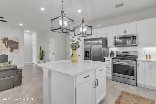 10035 SW Captiva Dr, Port St Lucie, FL 34987 - kitchen featuring appliances with stainless steel finishes, open floor plan, light tile patterned flooring, recessed lighting, and decorative backsplash