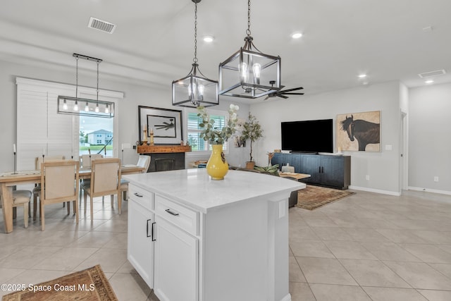 10035 SW Captiva Dr, Port St Lucie, FL 34987 - kitchen featuring light tile patterned flooring, a kitchen island, plenty of natural light, and recessed lighting