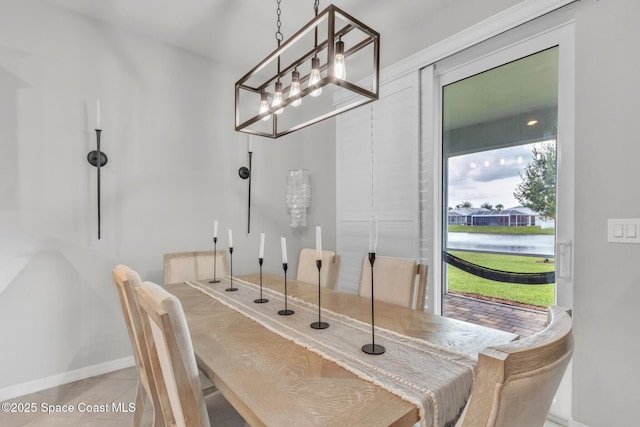 10035 SW Captiva Dr, Port St Lucie, FL 34987 - dining room featuring tile patterned floors and a water view