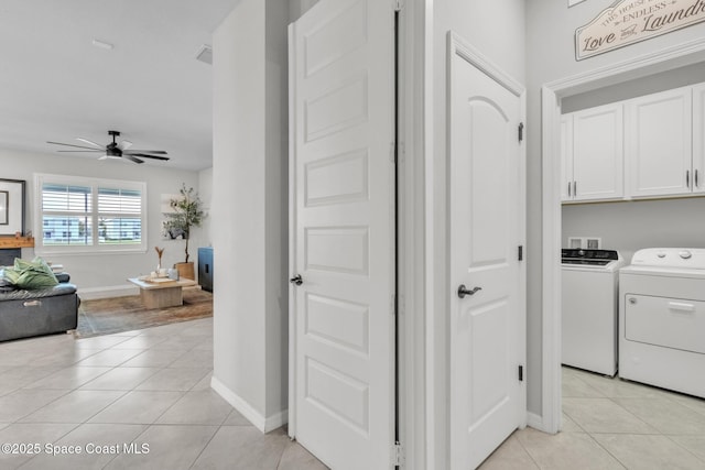 10035 SW Captiva Dr, Port St Lucie, FL 34987 - washroom featuring cabinet space, light tile patterned floors, ceiling fan, and washer and clothes dryer