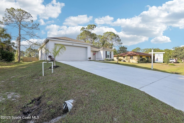 982 Pyracantha St NW, Palm Bay, FL 32907 - view of front of home with driveway, a garage, and stucco siding