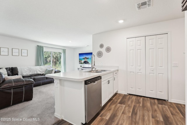 982 Pyracantha St NW, Palm Bay, FL 32907 - kitchen with dishwasher, a peninsula, light countertops, white cabinetry, and dark wood-type flooring
