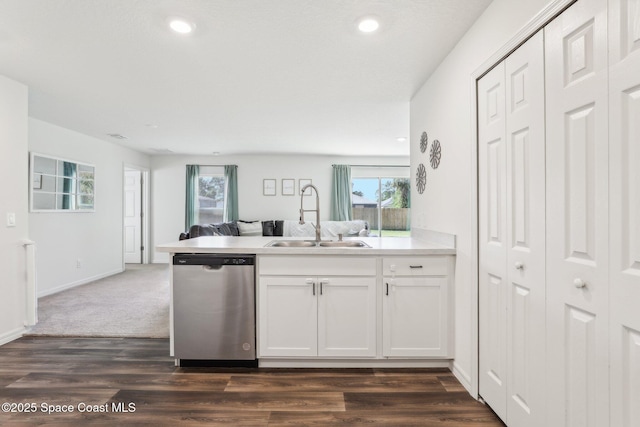 982 Pyracantha St NW, Palm Bay, FL 32907 - kitchen featuring stainless steel dishwasher, open floor plan, a peninsula, white cabinetry, and healthy amount of natural light