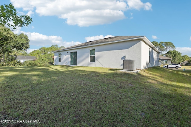 982 Pyracantha St NW, Palm Bay, FL 32907 - rear view of house featuring stucco siding and a lawn