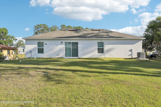982 Pyracantha St NW, Palm Bay, FL 32907 - rear view of house featuring stucco siding, a lawn, and a shingled roof
