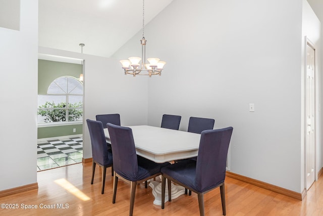 1459 Crane Creek Blvd, Melbourne, FL 32940 - dining area featuring light wood-style flooring, a chandelier, and high vaulted ceiling