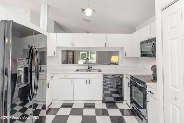 1459 Crane Creek Blvd, Melbourne, FL 32940 - kitchen featuring black appliances, tile patterned floors, white cabinets, light countertops, and lofted ceiling
