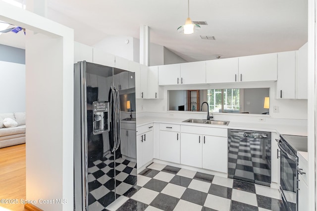 1459 Crane Creek Blvd, Melbourne, FL 32940 - kitchen featuring black appliances, light floors, vaulted ceiling, light countertops, and white cabinets