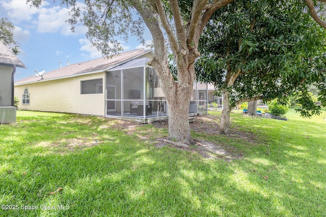1459 Crane Creek Blvd, Melbourne, FL 32940 - view of green lawn featuring a lanai