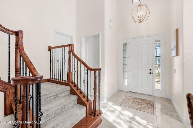 8522 Strom Park Dr, Melbourne, FL 32940 - foyer featuring a high ceiling, a chandelier, stairs, and light tile patterned floors