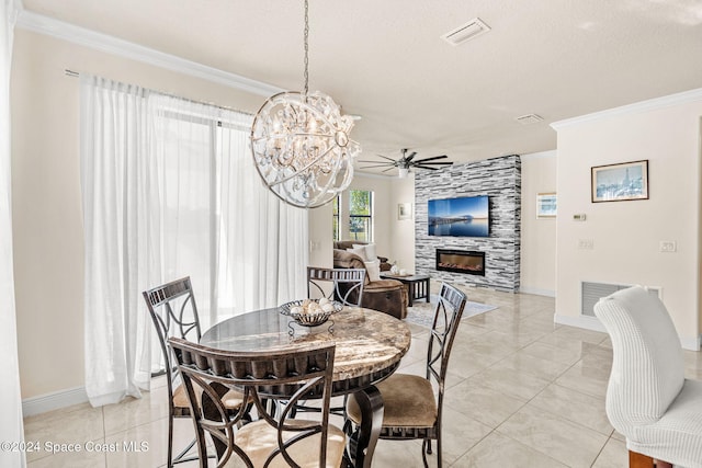 8522 Strom Park Dr, Melbourne, FL 32940 - dining room with a tiled fireplace, ornamental molding, a chandelier, ceiling fan, and light tile patterned floors