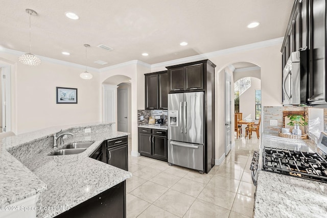 8522 Strom Park Dr, Melbourne, FL 32940 - kitchen featuring stainless steel appliances, arched walkways, tasteful backsplash, light stone counters, and crown molding