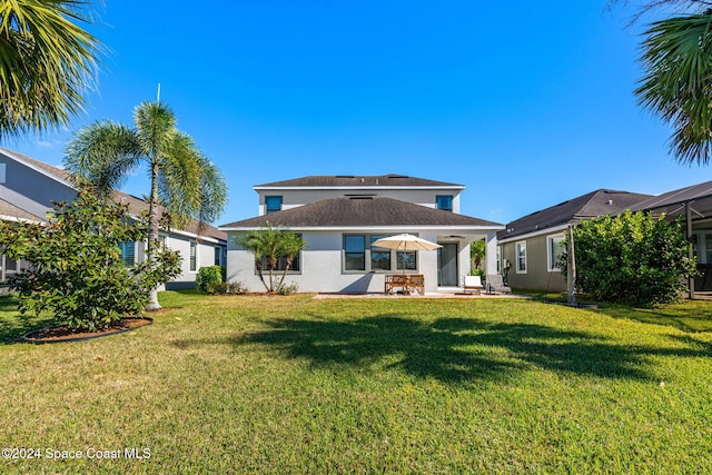 8522 Strom Park Dr, Melbourne, FL 32940 - back of property with a lawn, a patio, and stucco siding
