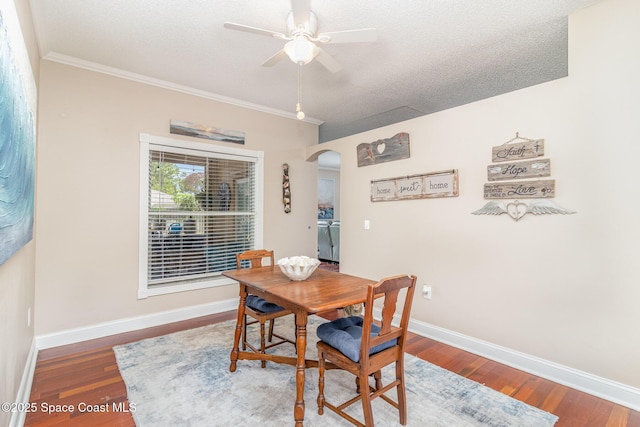 1510 Gardenton St NW, Palm Bay, FL 32907 - dining area featuring arched walkways, ceiling fan, wood finished floors, a textured ceiling, and ornamental molding