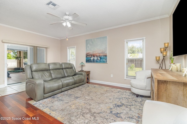 1510 Gardenton St NW, Palm Bay, FL 32907 - living area featuring wood finished floors, ceiling fan, healthy amount of natural light, and crown molding