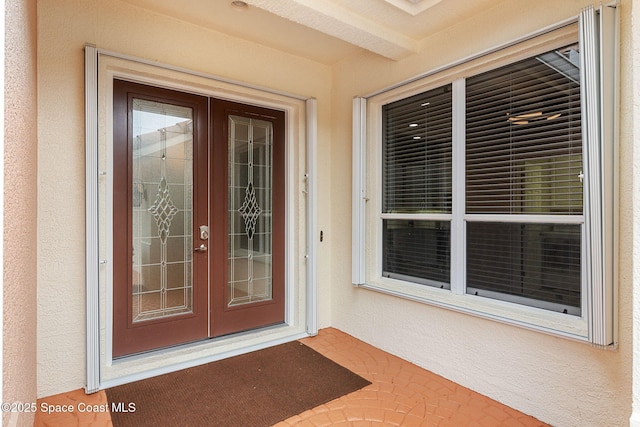 172 Whaler Dr, Melbourne Beach, FL 32951 - view of exterior entry with french doors and stucco siding