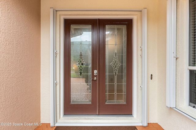 172 Whaler Dr, Melbourne Beach, FL 32951 - view of exterior entry with french doors and stucco siding