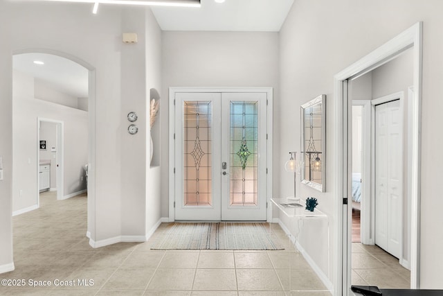 172 Whaler Dr, Melbourne Beach, FL 32951 - entryway featuring french doors, arched walkways, and tile patterned flooring