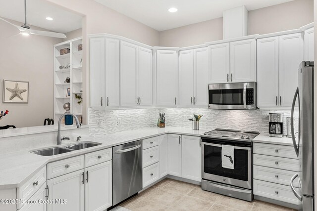 172 Whaler Dr, Melbourne Beach, FL 32951 - kitchen featuring appliances with stainless steel finishes, decorative backsplash, light countertops, white cabinets, and ceiling fan