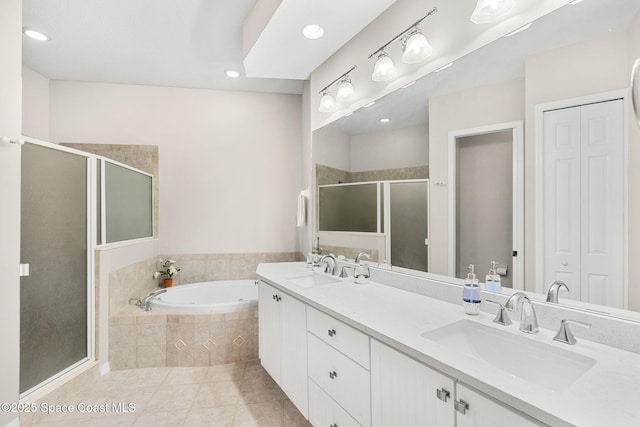 172 Whaler Dr, Melbourne Beach, FL 32951 - bathroom featuring double vanity, a stall shower, a bath, tile patterned flooring, and a closet