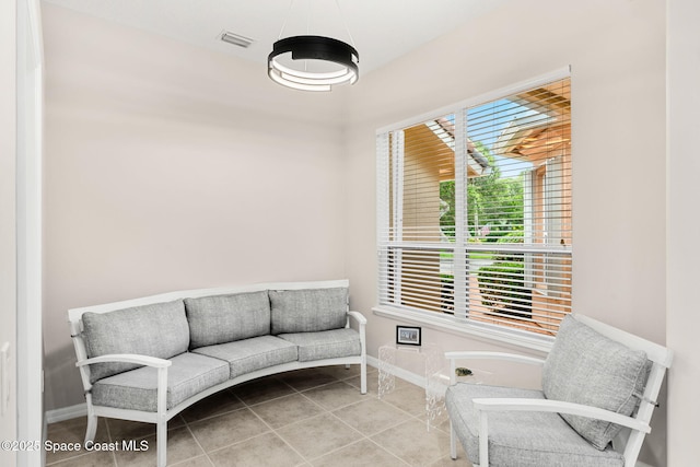 172 Whaler Dr, Melbourne Beach, FL 32951 - living area featuring tile patterned flooring and baseboards