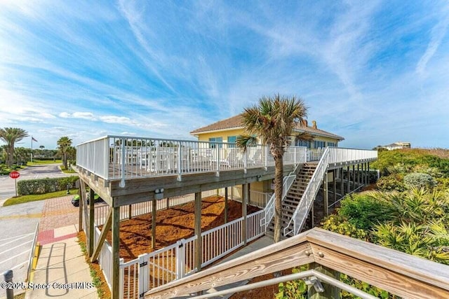 172 Whaler Dr, Melbourne Beach, FL 32951 - rear view of property featuring stairs and a wooden deck