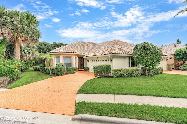 172 Whaler Dr, Melbourne Beach, FL 32951 - mediterranean / spanish-style house with an attached garage, concrete driveway, stucco siding, and a front lawn