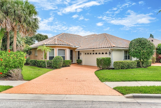 172 Whaler Dr, Melbourne Beach, FL 32951 - mediterranean / spanish home featuring stucco siding, an attached garage, decorative driveway, a tile roof, and a front yard