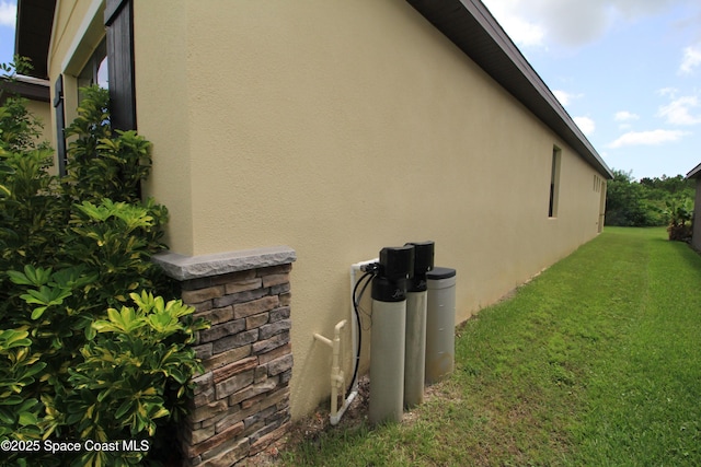 947 Remington Green Dr SE, Palm Bay, FL 32909 - view of side of property featuring stucco siding and a lawn