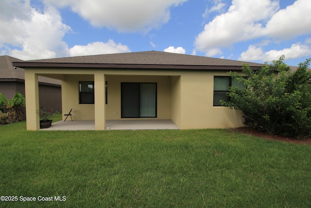947 Remington Green Dr SE, Palm Bay, FL 32909 - back of property with a patio, stucco siding, and a lawn