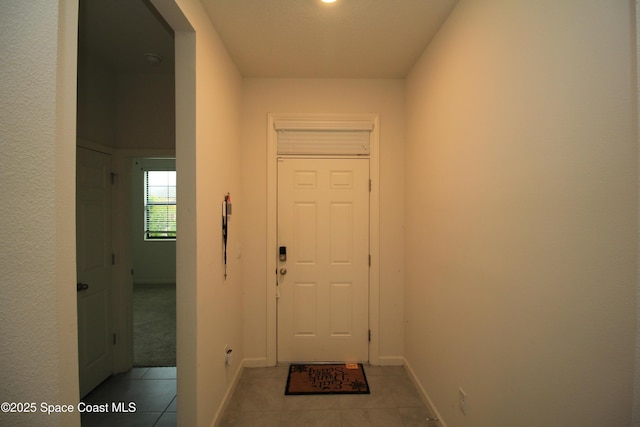 947 Remington Green Dr SE, Palm Bay, FL 32909 - doorway with light tile patterned floors and baseboards